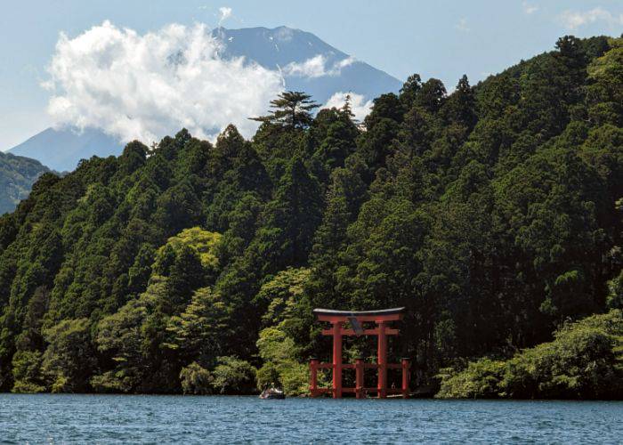 The famous lakeside torii gate of Hakone Shrine, with the mountain appearing in the distance.