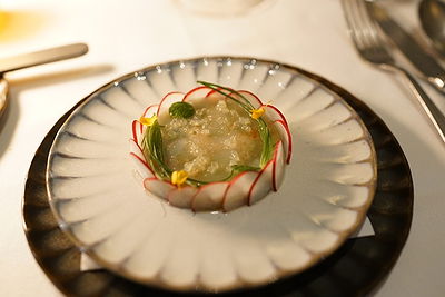 Gourmet dish with radish and herbs on an elegant plate