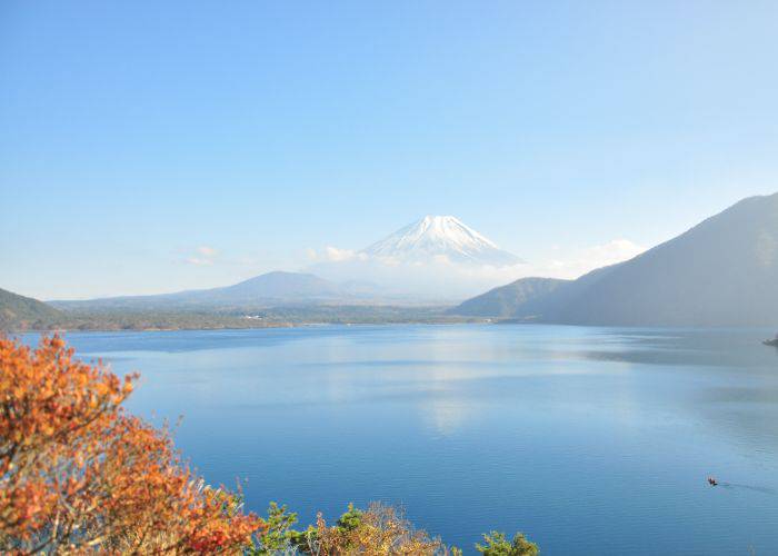 The natural beauty of Lake Motosuko and Mt. Fuji, with autumnal leaves in the foreground.