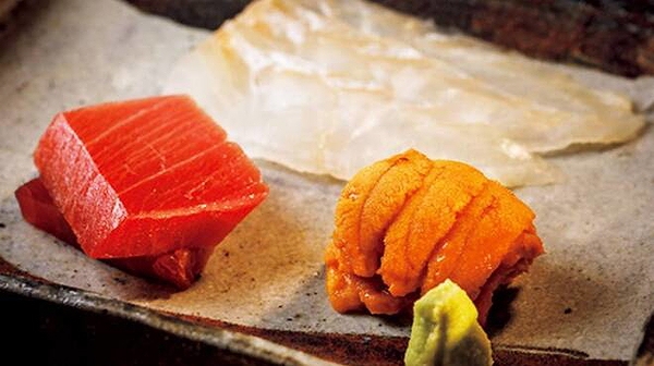 Elegant sushi presentation with fresh sashimi assortment on a plate
