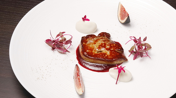 Gourmet foie gras dish with fig and edible flowers
