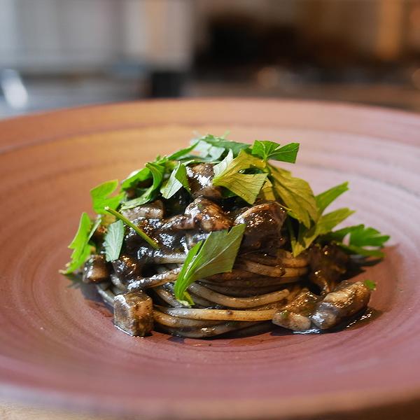 Gourmet pasta dish with mushrooms and fresh herbs