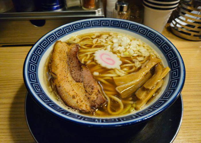 A traditional bowl of ramen at Niboshi Soba RU., showing off chashu pork, menma, fish cake and noodles.