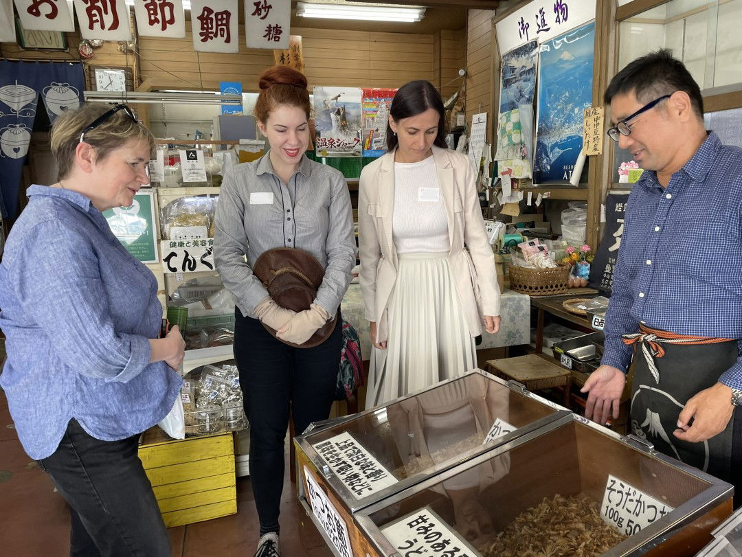 A food tour in Atami where a local guide is explaining Japanese ingredients.