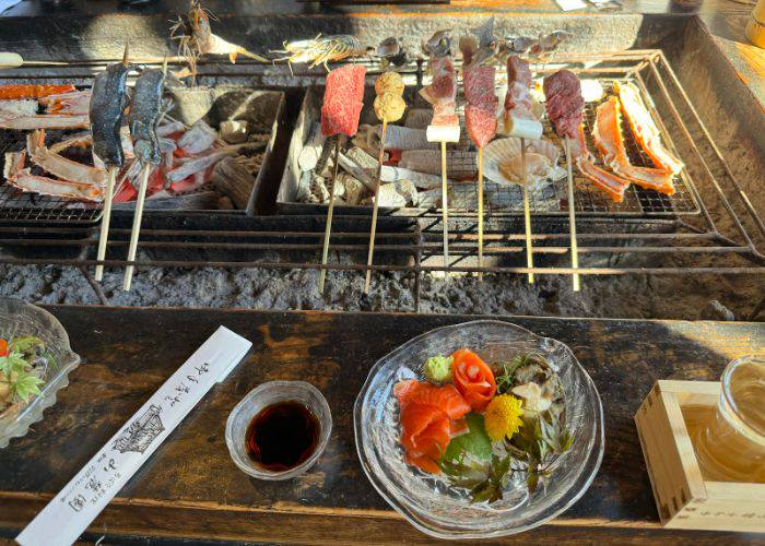 Skewers being grilled over charcoal at Sanrokuen.