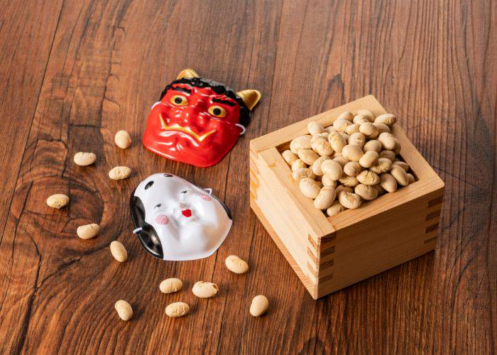 Traditional setsubun icons of demon masks and beans for throwing.