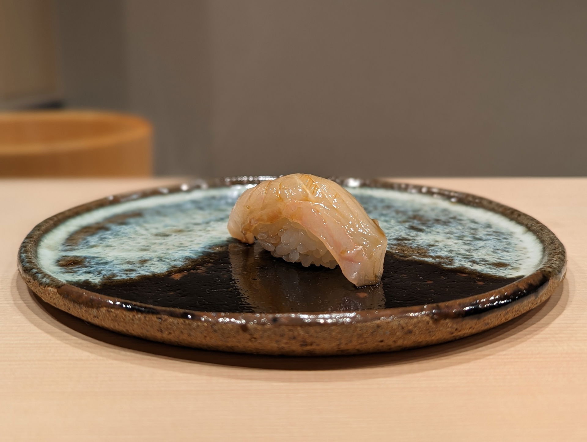 A luxurious piece of nigiri sushi, waiting to be eaten.