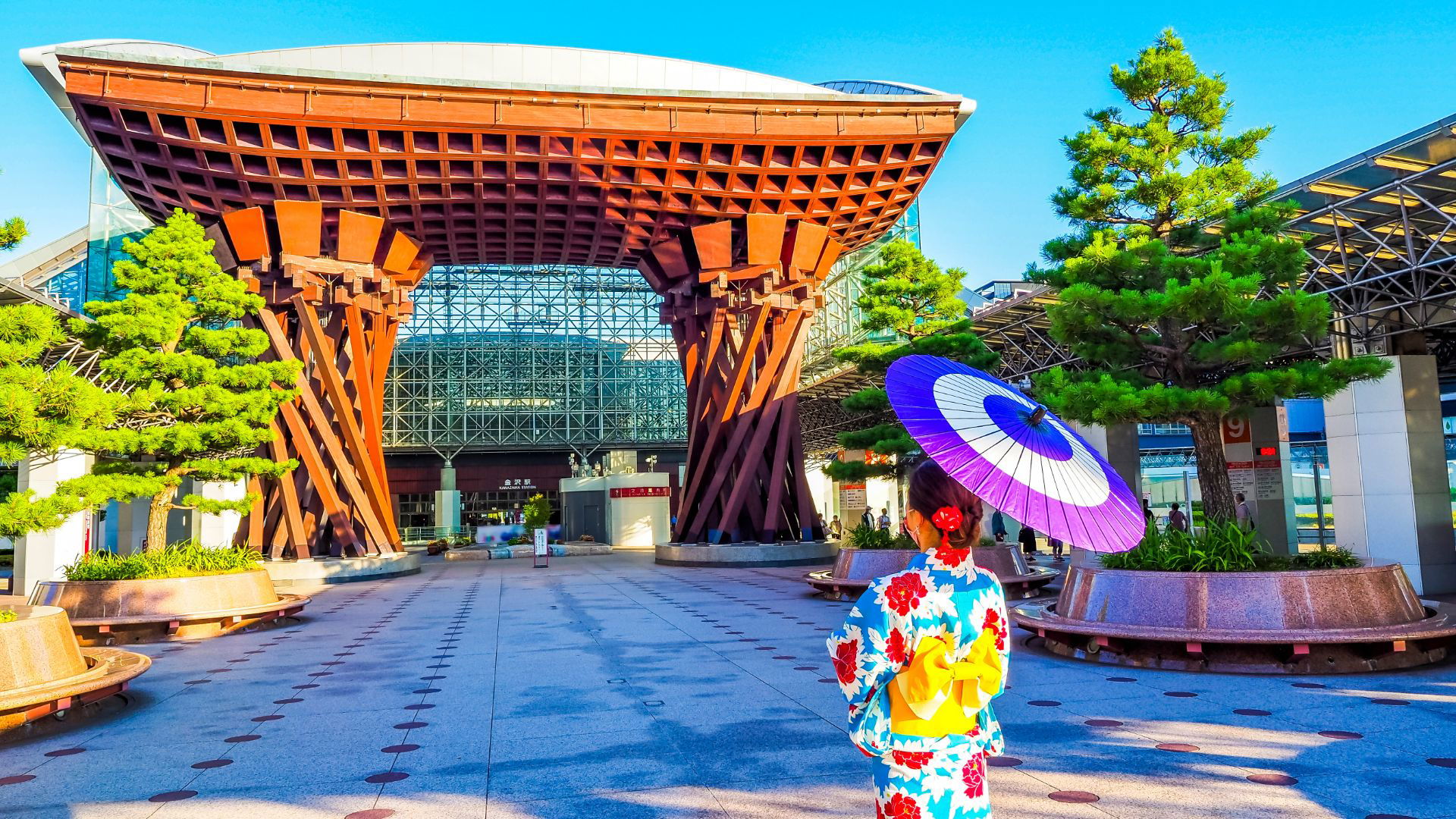 Woman in kimono with umbrella at Kanazawa Station