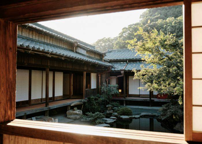 A picturesque Japanese garden in Kagoshima, looking out from a traditional home.