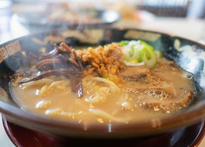 Kagoshima black wagyu beef ramen, topped with meat, mushrooms and spring onions.