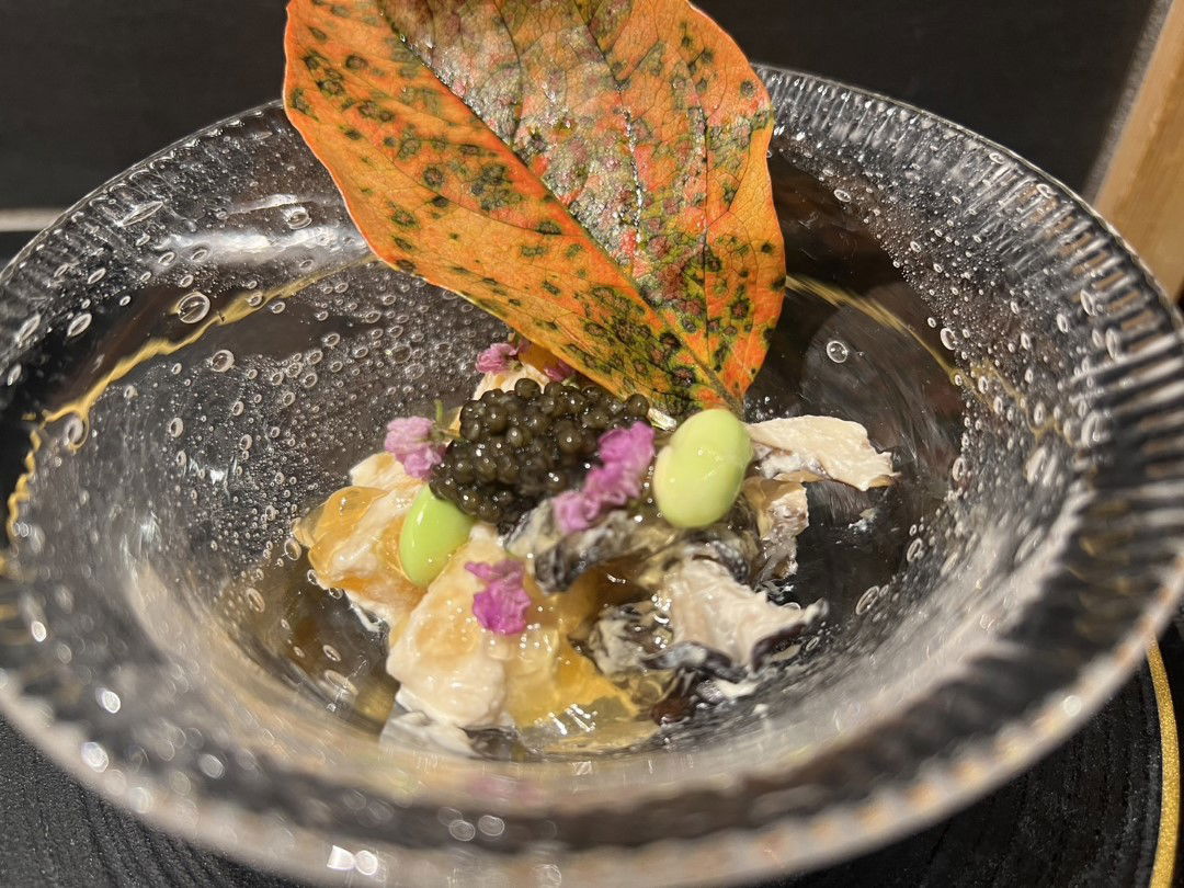 A small salad served with a natural fall foliage decoration at Azabu Saotome.