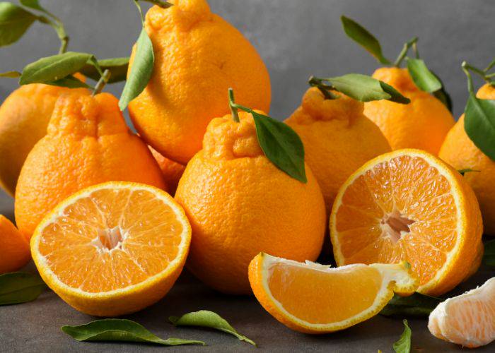 A selection of dekopon oranges, some split in half.