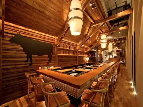 Cozy steakhouse interior with wooden decor and bar seating