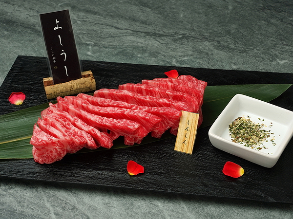 Wagyu beef slices on slate with garnish at upscale restaurant