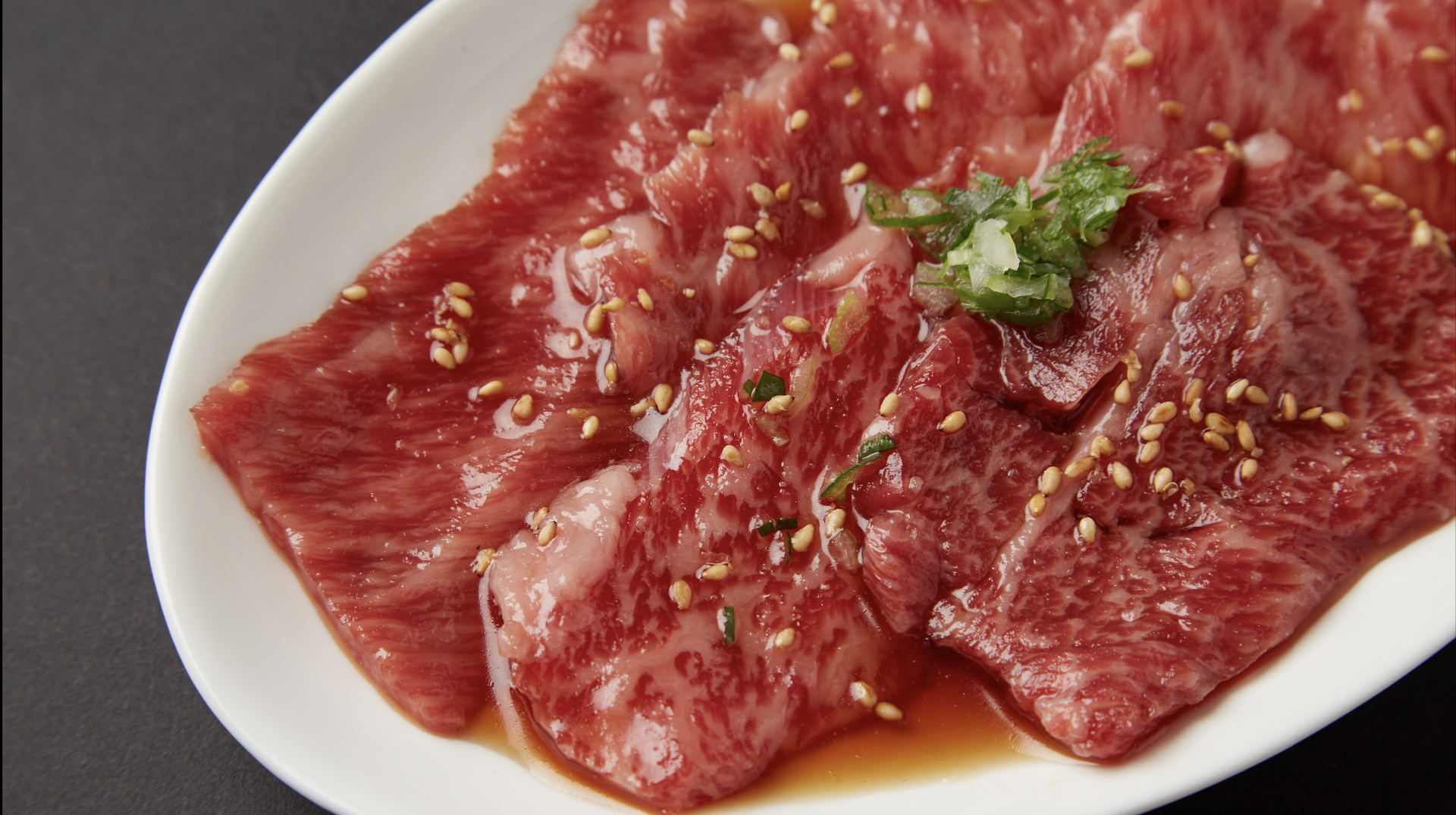 Marinated slices of tender meat at Yakiniku Shuka Rien, ready for grilling.