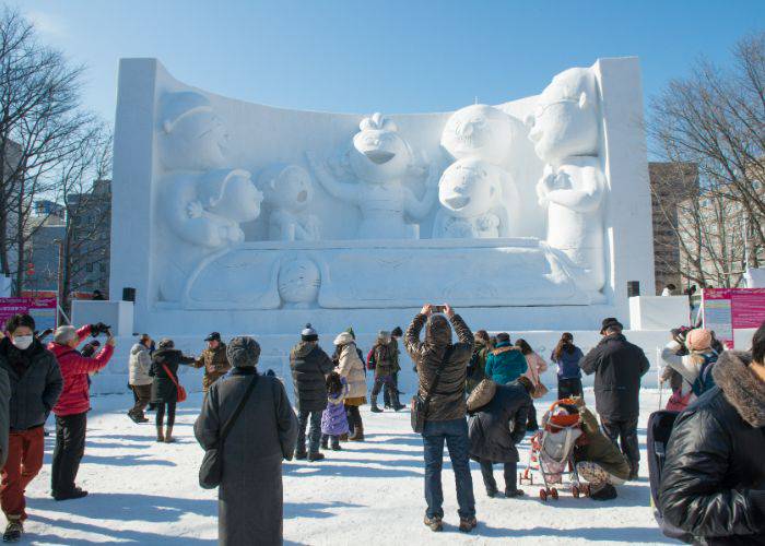 The awe-inspiring snow sculptures of the Sapporo Snow Festival, dwarfing visitors with its size.