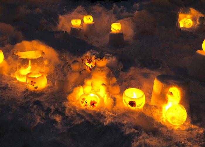 Glowing candles and snow sculptures at The Snow Light Path Festival in Otaru.