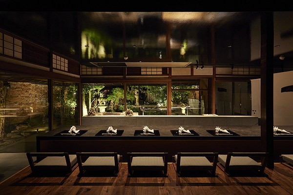 Elegant restaurant interior with sleek, modern design and lush garden view