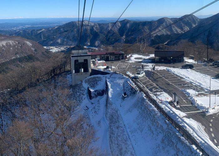 Looking out over the snowy mountain ranges of Nikko while riding the Akechidaira Ropeway.