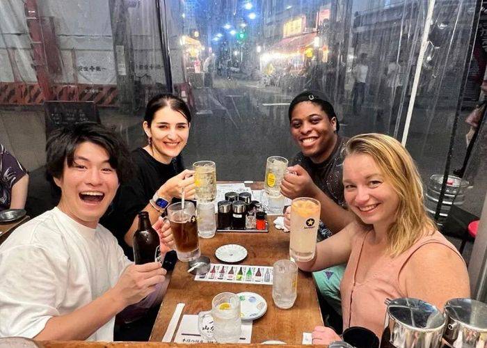 People smiling and drinking at this bar-hopping tour in Asakusa.