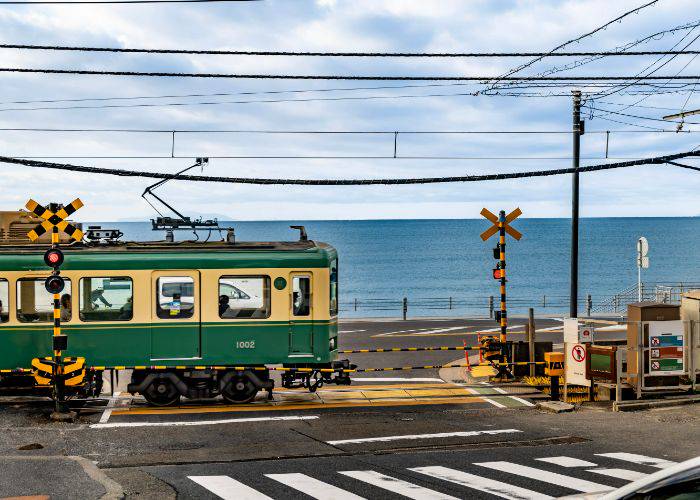 The Enoden train running through Kamakura, set against the Sea of Japan.