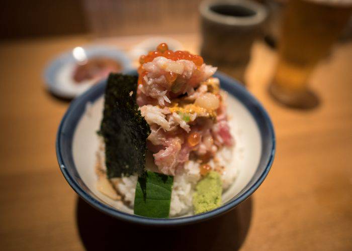 The seafood kaisendon at Tsujihan, viral for its sky-high pile of premium seafood toppings.