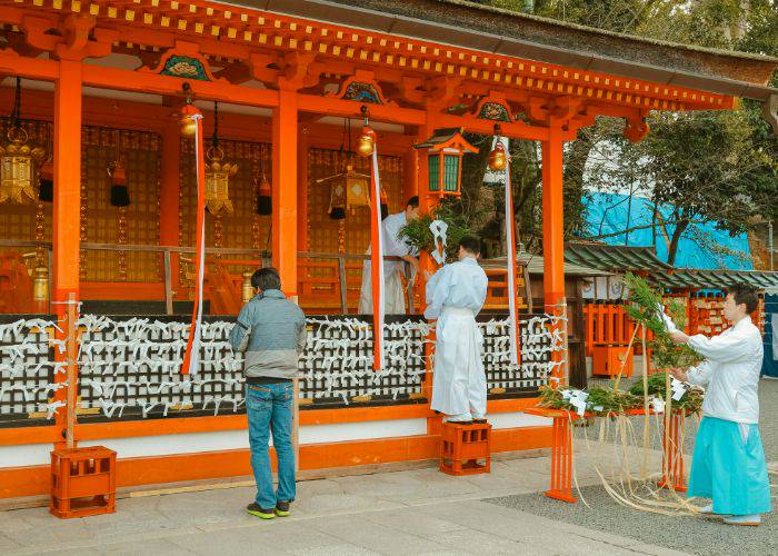 A man praying at a temple in Kyoto.