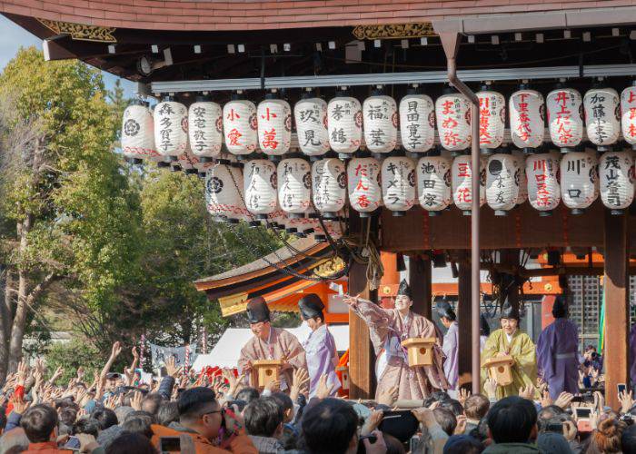 Priests throwing out beans at a setsubun festival in Japan.