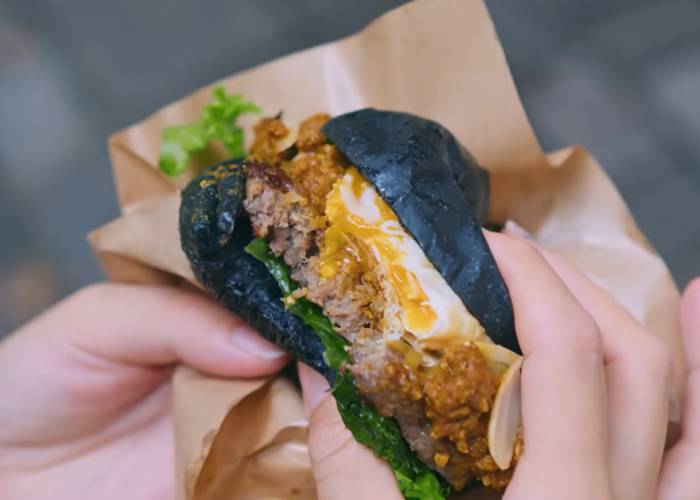 The unique B.C. Burger of Bonnie&Fried.Tokyo, topping a beef burger with curry, egg and more.