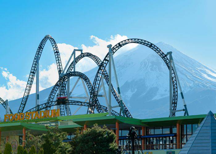 A rollercoaster at Fuji-Q Highland, set against Mt. Fuji.