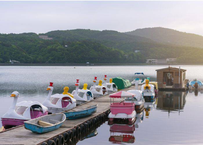 The paddleboats lined up next to a pier on Lake Kawaguchiko.