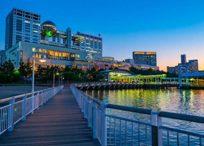 The pier of Odaiba; the water reflects the glowing lights of DiverCity.