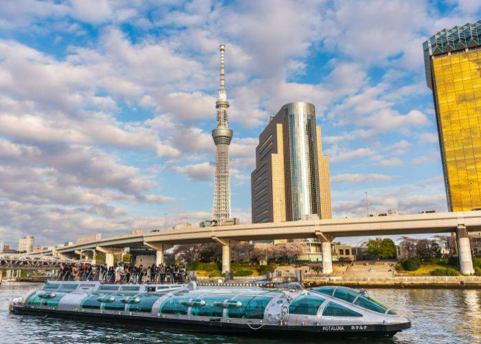 The Tokyo Water Bus, traveling between Asakusa and Odaiba; behind it, the Tokyo Skytree.