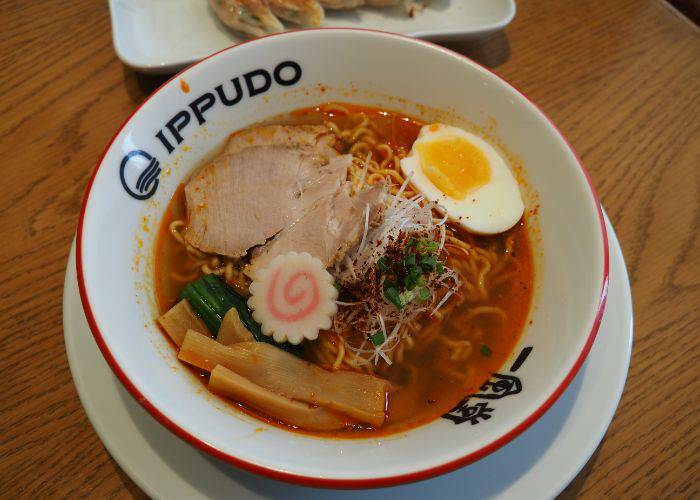 A bowl of Ippudo Ramen, featuring noodles, pork, egg, bamboo shoots, fish cake and more.