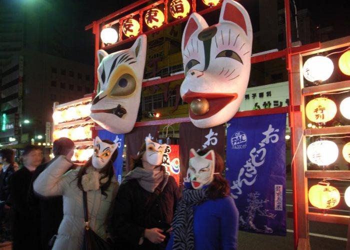 A group of people in fox masks celebrating the Oji fox festival