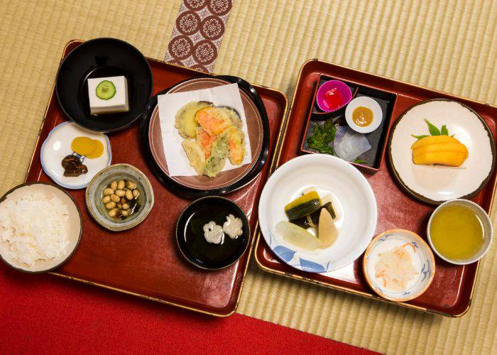 Trays of shojin ryori, featuring small dishes of vegetables, rice and more.