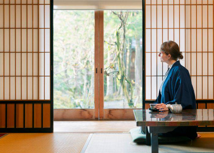 A women in a yukata drinking tea in a ryokan.