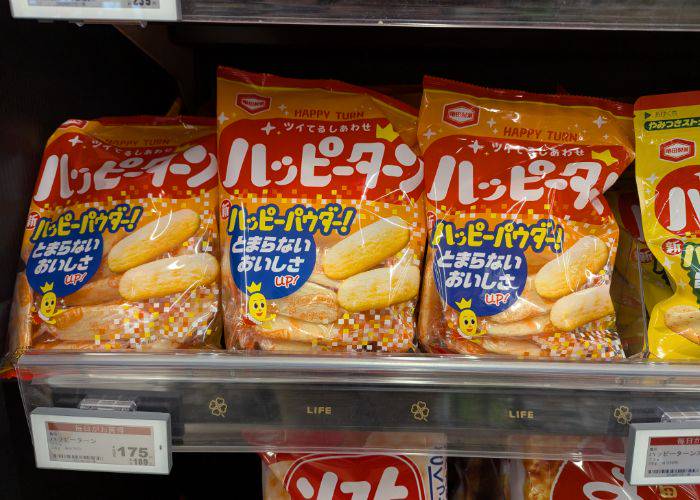 Bags of Happy Turn senbei on grocery shelves