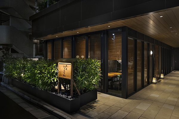 Chic restaurant exterior with modern design and greenery