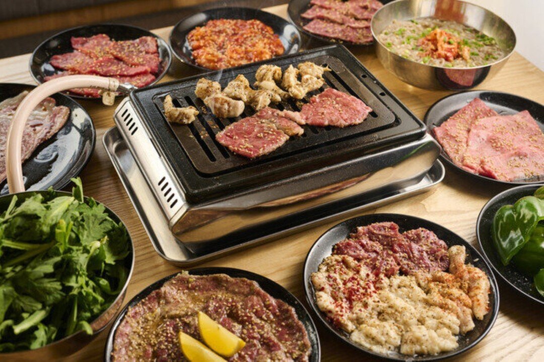 Assorted Korean BBQ dishes with meats and vegetables