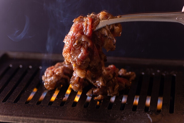 Delicious grilled meat sizzling over flames at a restaurant