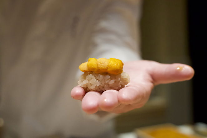 A carefully crafted piece of sea urchin nigiri sushi.