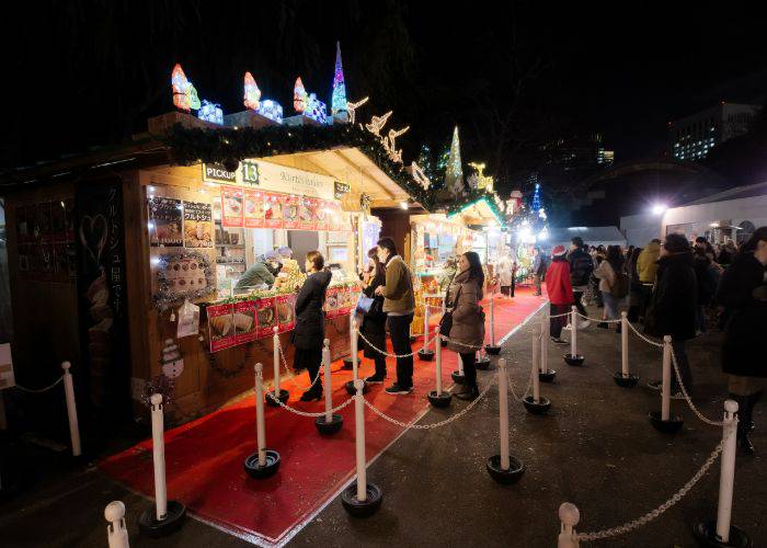 People lining up for Christmas food and drinks at a Christmas market in Japan.