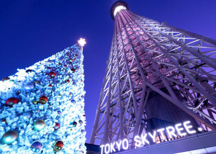 Tokyo Skytree at Christmas, with a decorated Christmas tree next to it.