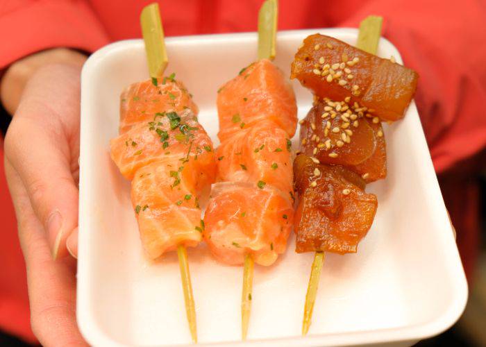 Salmon and tuna sashimi skewers with carpaccio flavoring at Nishiki Market