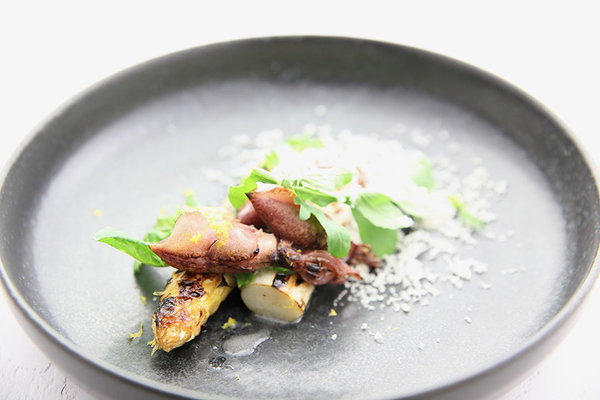 Gourmet dish at a restaurant on a stylish black plate