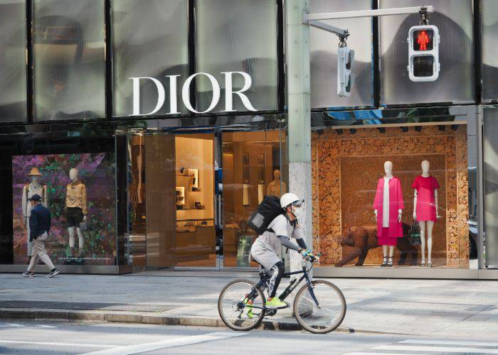 Someone cycling past the Dior store in Ginza.