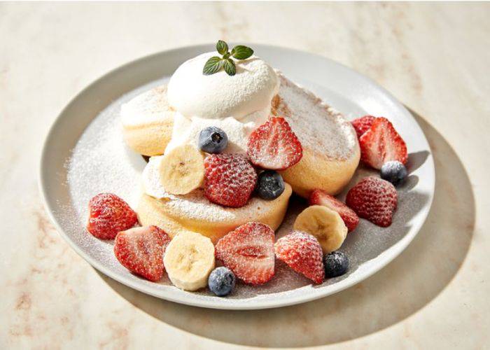 Souffle pancakes topped with strawberries, blueberries and bananas at Flipper's