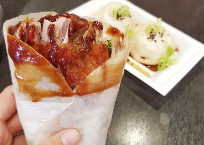 A thin crepe-like pancake wrapped around pieces of Peking duck