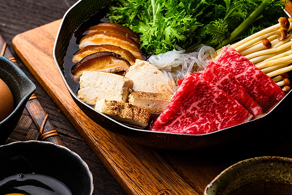 Gourmet Japanese hot pot with beef, tofu, and mushrooms